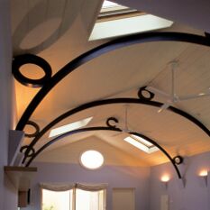 based on a boat shed, with rolled t trusses and concealed lighting on alternate corbels