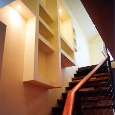 extra storage is created as the stair angles dramatically out from the wall